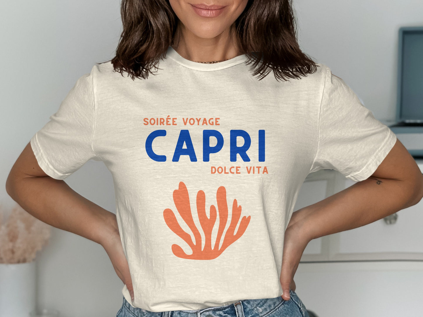 Cream t-shirt with "Soirée Voyage Capri Dolce Vita" text and orange coral graphic.