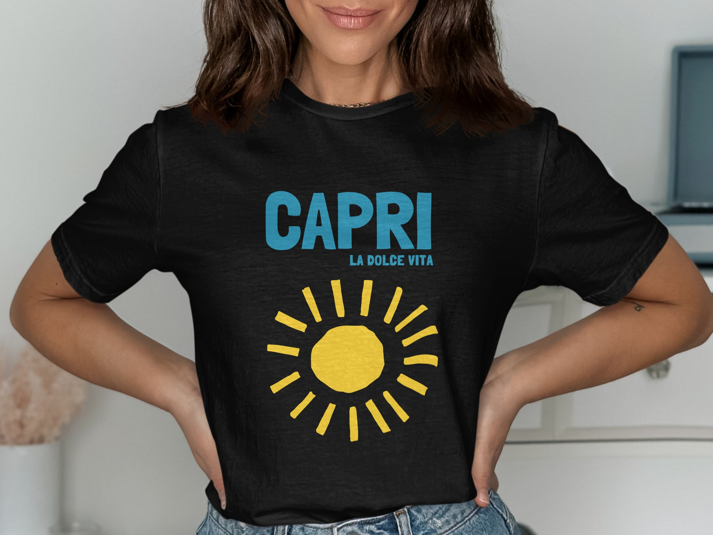 Black t-shirt with "CAPRI LA DOLCE VITA" and a yellow sun graphic.