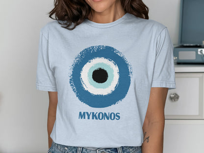 Light blue t-shirt with a blue, black, and white evil eye graphic and "MYKONOS" text.