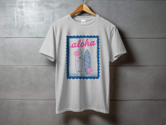 White t-shirt with blue postage stamp graphic featuring two surfboards and pink flowers.