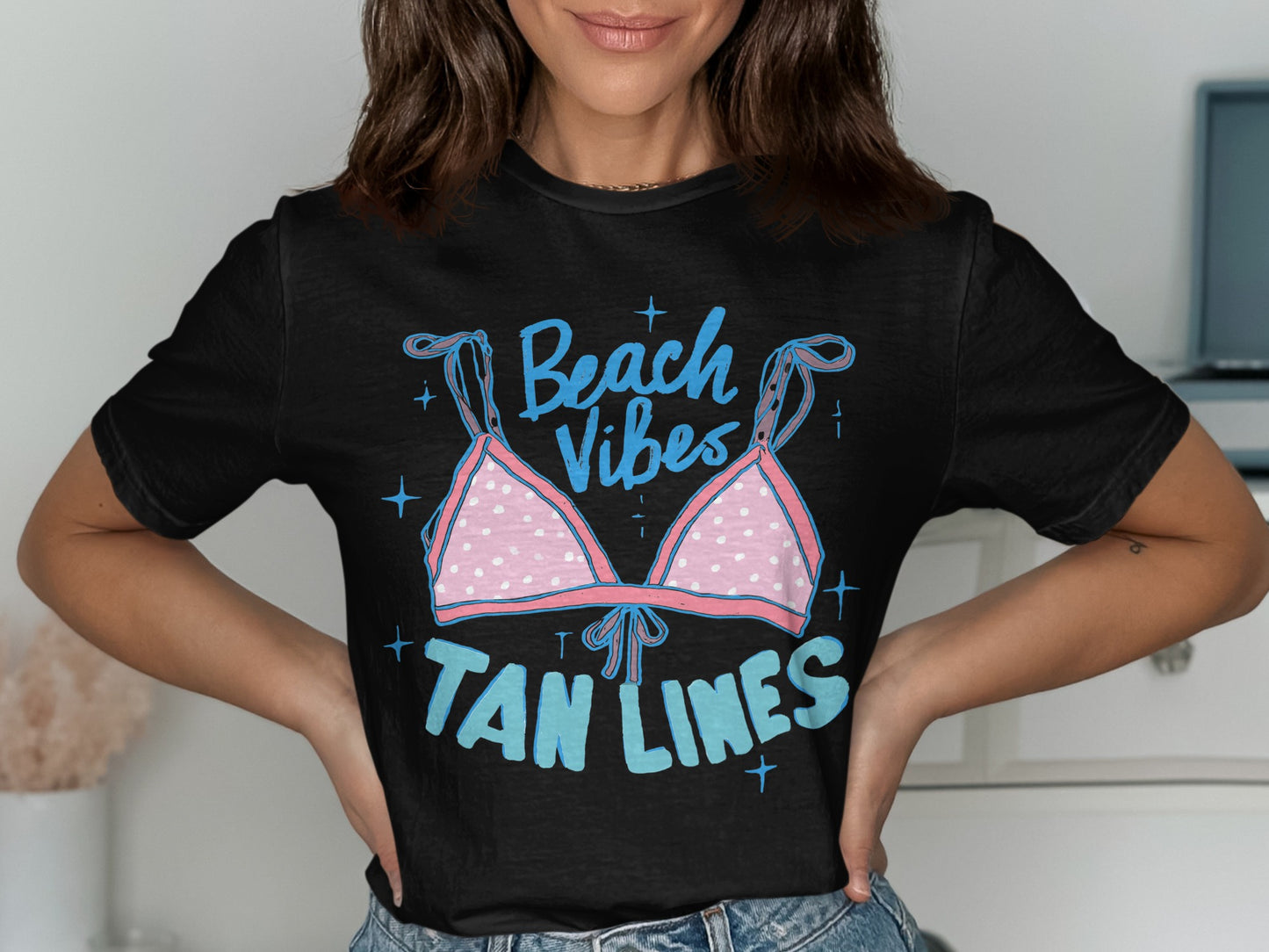 Black t-shirt with "Beach Vibes Tan Lines" text and pink polka dot bikini top graphic.