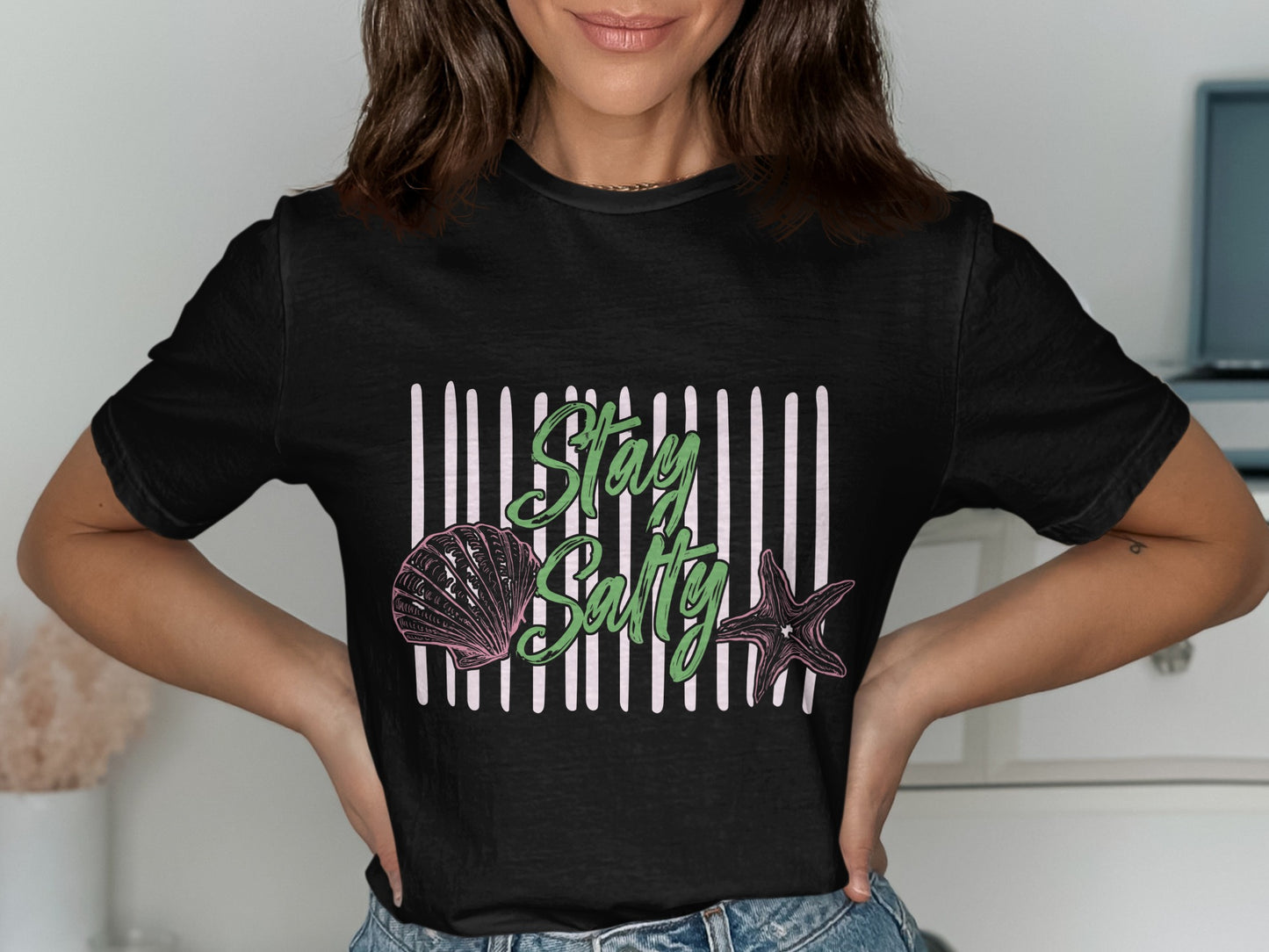 Black t-shirt with "Stay Salty" text, seashell, and starfish graphic.