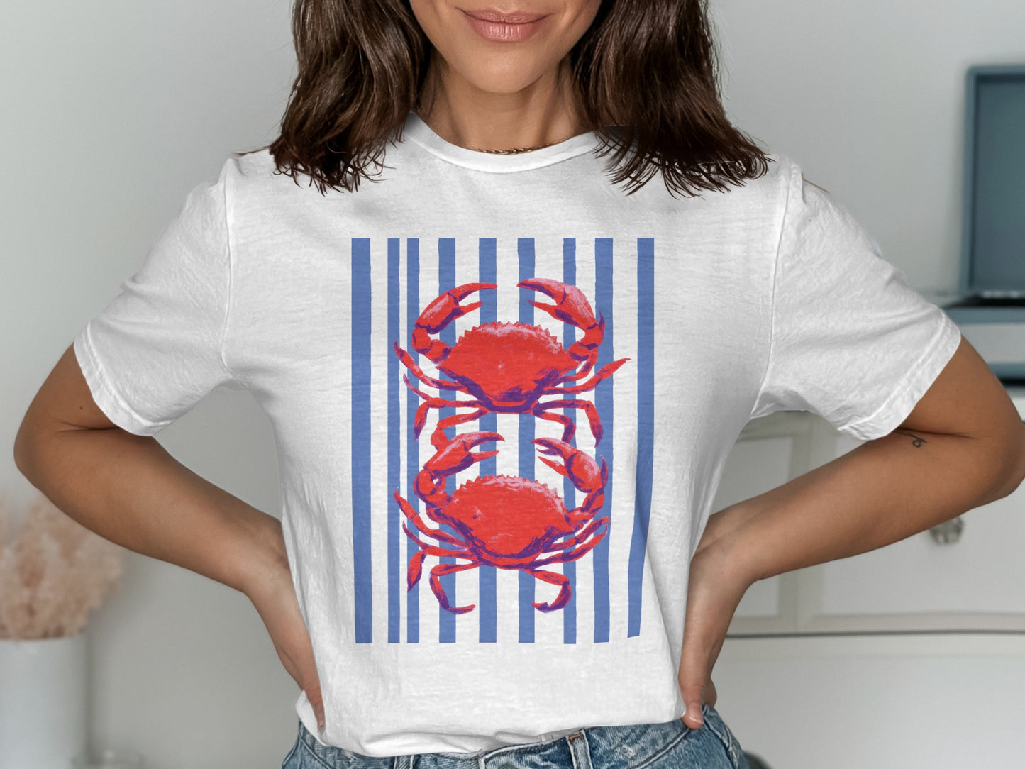 White t-shirt with two red crabs centered on blue and white stripes.