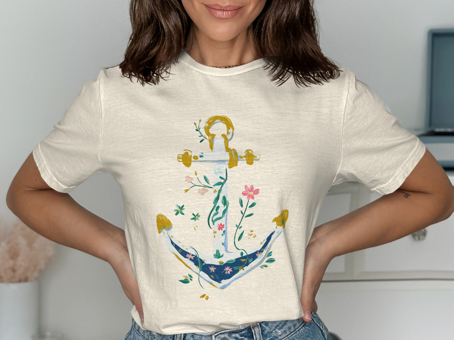Cream t-shirt with a gold anchor adorned with floral vines.