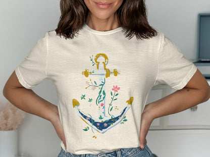 Cream t-shirt with a gold anchor adorned with floral vines.