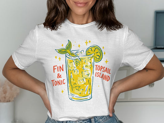 White t-shirt with a graphic of a mermaid tail in a cocktail glass.