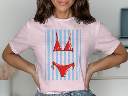 Pink t-shirt with a red bikini and blue and white striped background graphic.