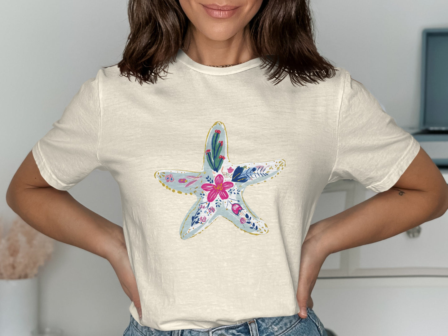 Cream t-shirt with a colorful floral starfish graphic.