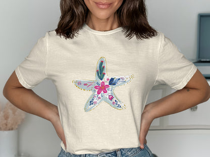 Cream t-shirt with a colorful floral starfish graphic.