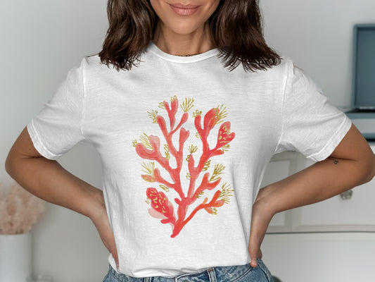 White t-shirt with a red coral graphic and gold accents.