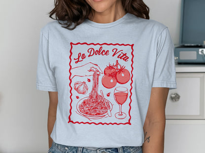 T-shirt featuring a graphic of pasta, tomatoes, garlic, and wine with "La Dolce Vita" text.
