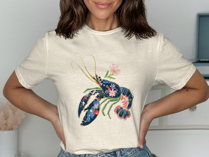 Cream t-shirt with a navy lobster design with floral accents.