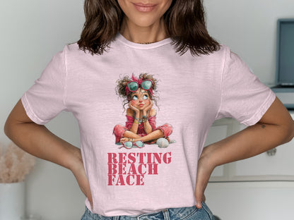 Woman wearing pink t-shirt with cartoon girl saying "Resting Beach Face".
