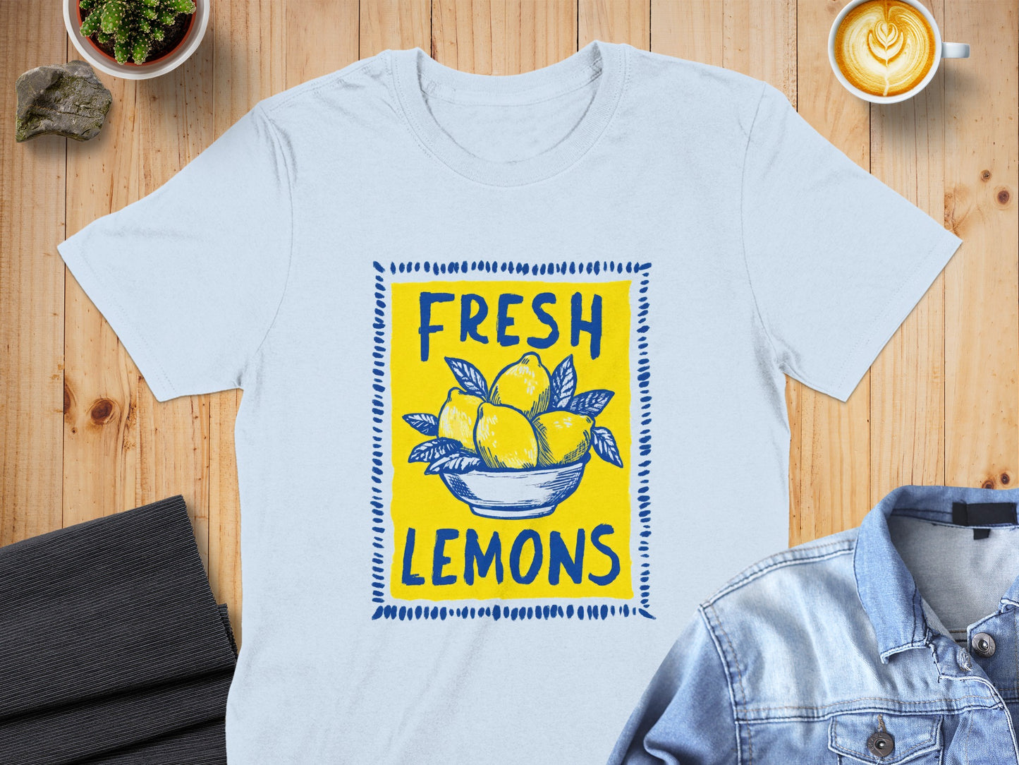 Light blue t-shirt featuring a yellow bowl of fresh lemons graphic.
