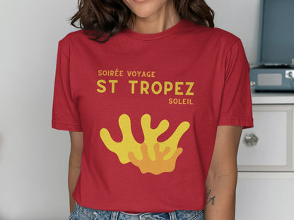 Red t-shirt with "Soirée Voyage St Tropez" and yellow coral graphic.