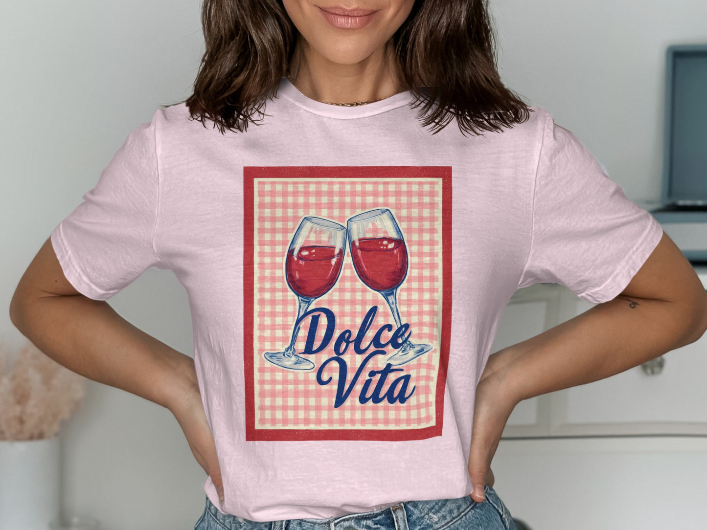 Pink t-shirt with red and white checkered border and "Dolce Vita" graphic of two wine glasses.