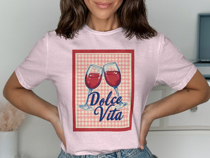 Pink t-shirt with red and white checkered border and "Dolce Vita" graphic of two wine glasses.