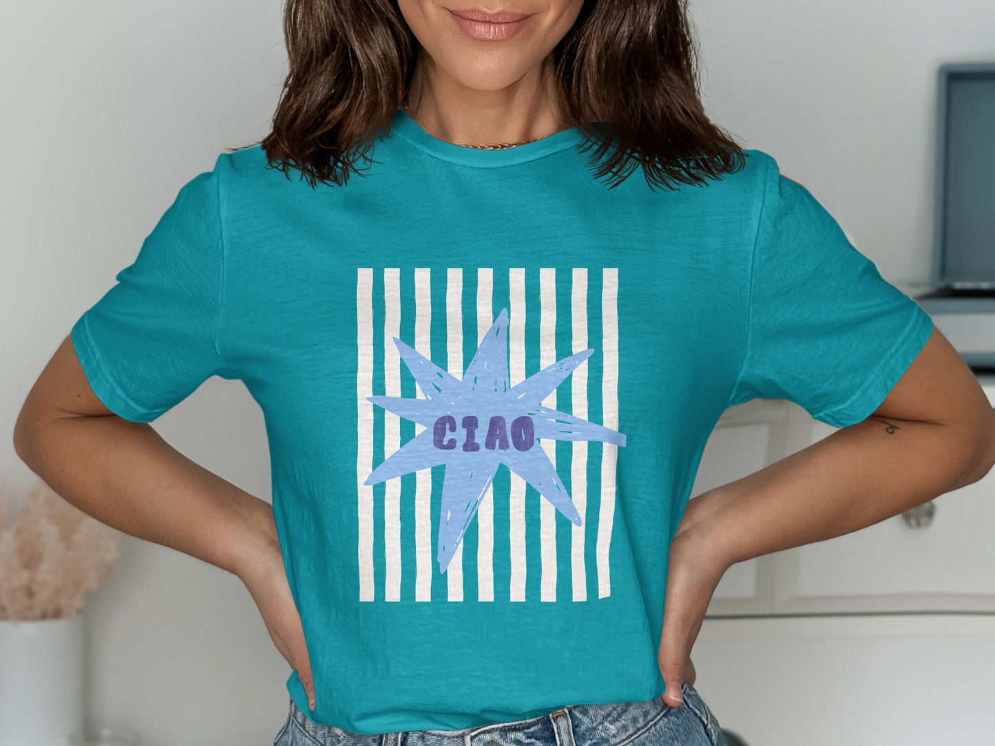 Turquoise t-shirt with a light blue starburst and "CIAO" text.