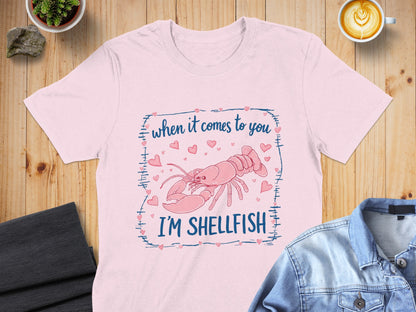 Pink t-shirt with lobster and text "when it comes to you I'M SHELLFISH".