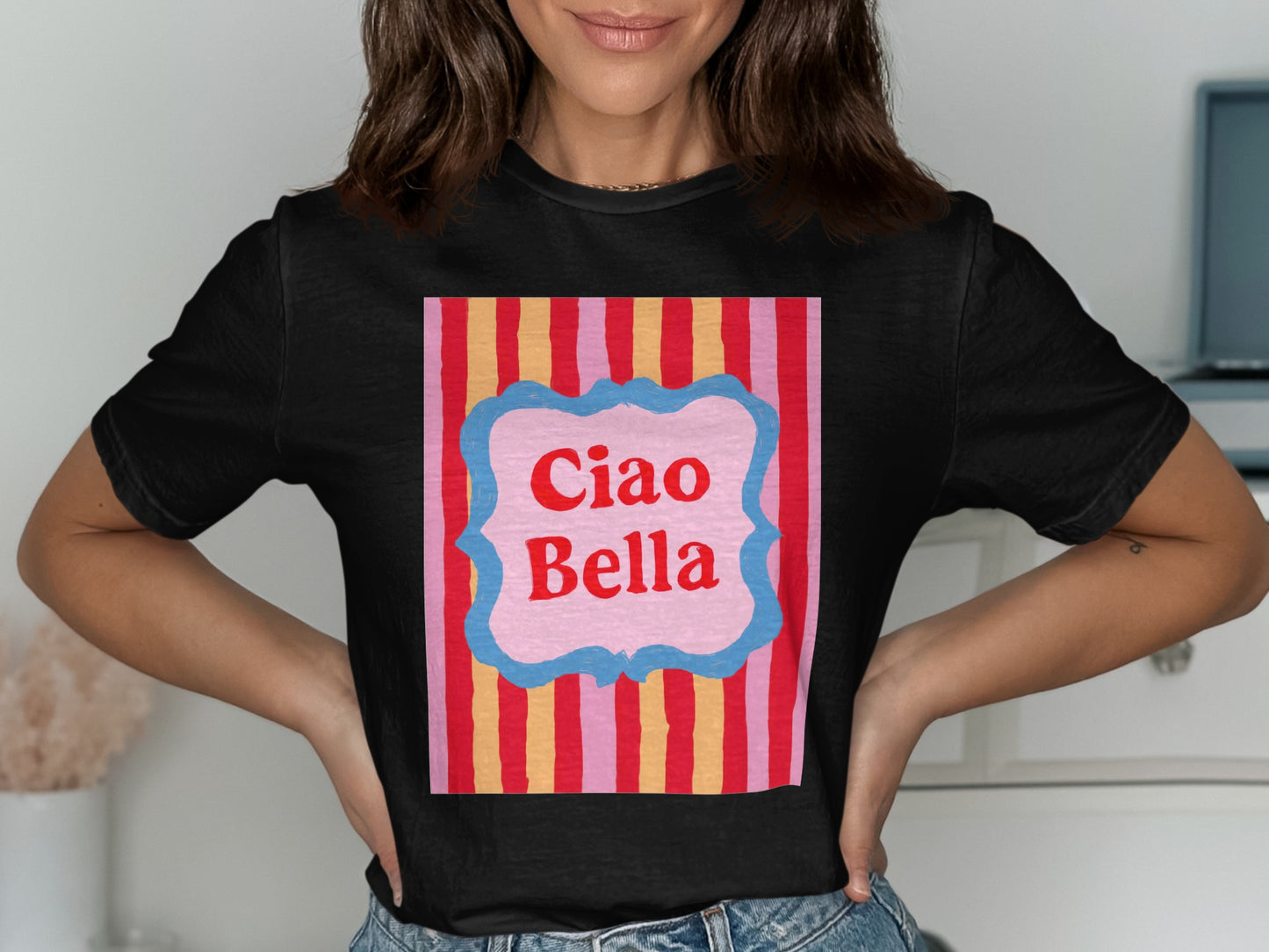 Black t-shirt with "Ciao Bella" text on striped background.