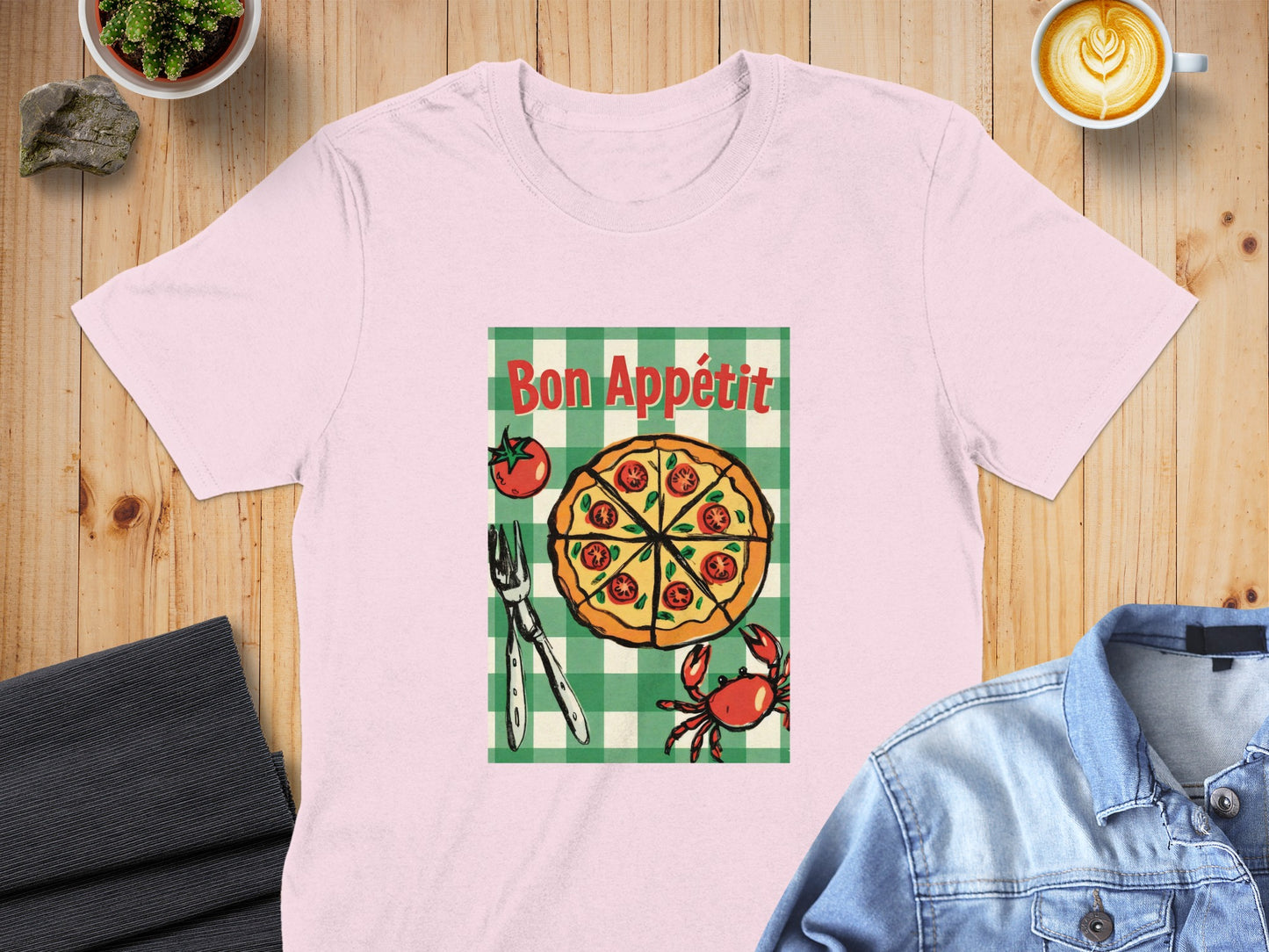 Pink t-shirt featuring a pizza slice with text "Bon Appétit" and a crab graphic.