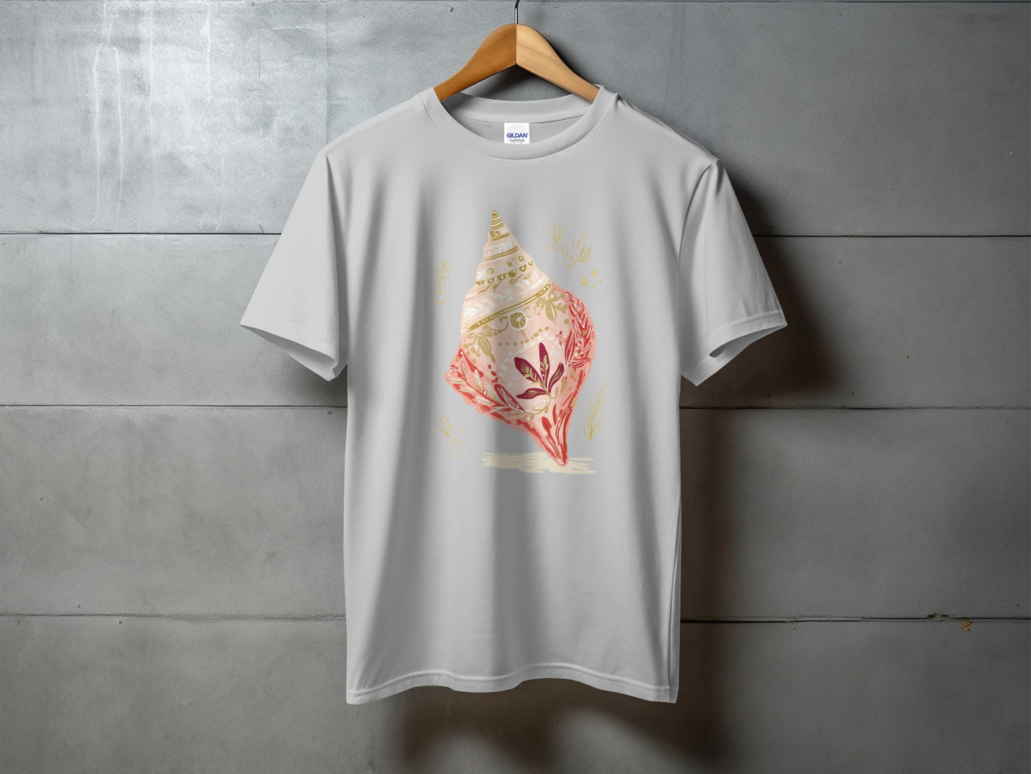 Light grey t-shirt with a watercolor seashell design featuring pink and gold accents.