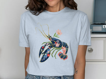 Light blue t-shirt with a navy lobster design featuring floral accents.