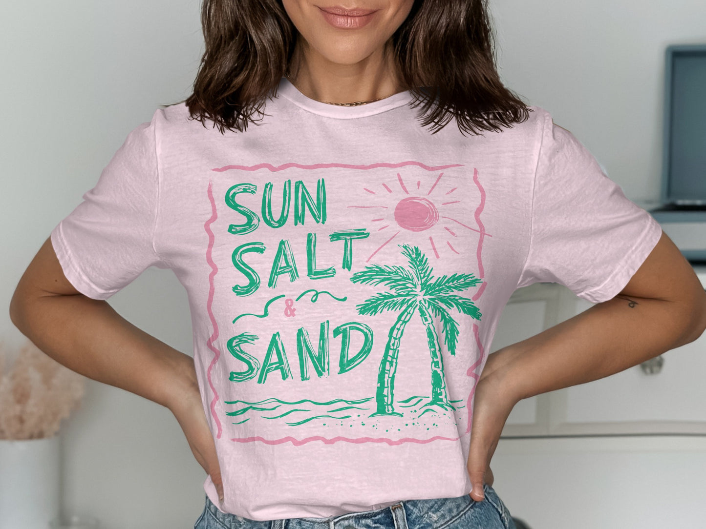 Pink t-shirt with "Sun Salt & Sand" text and a palm tree graphic.