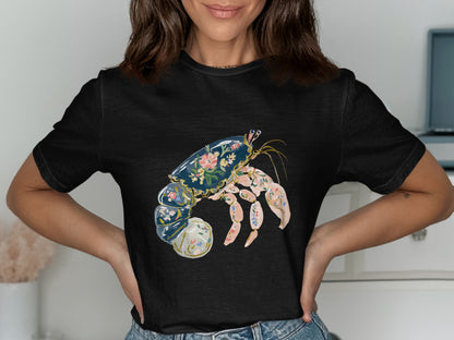 Black t-shirt featuring a stylized hermit crab illustration with floral accents.