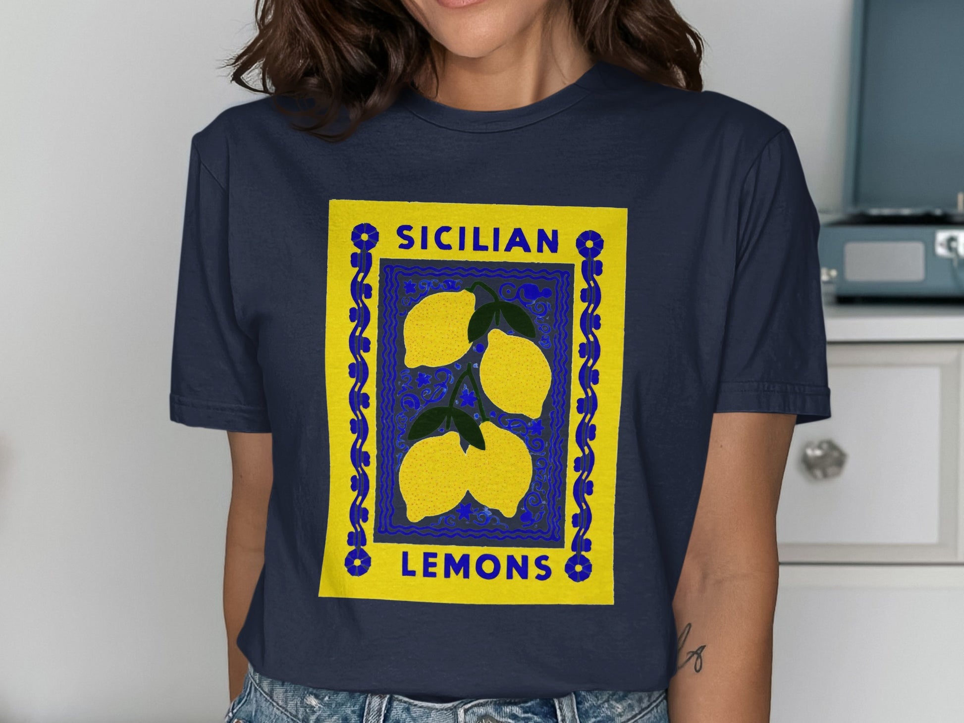Navy t-shirt with a blue and yellow framed illustration of three lemons.