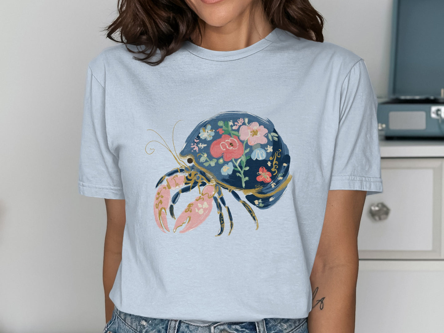 Light blue t-shirt with a dark blue lobster decorated with pink and red flowers.