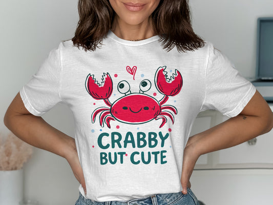White t-shirt with a smiling red crab and "Crabby But Cute" text.