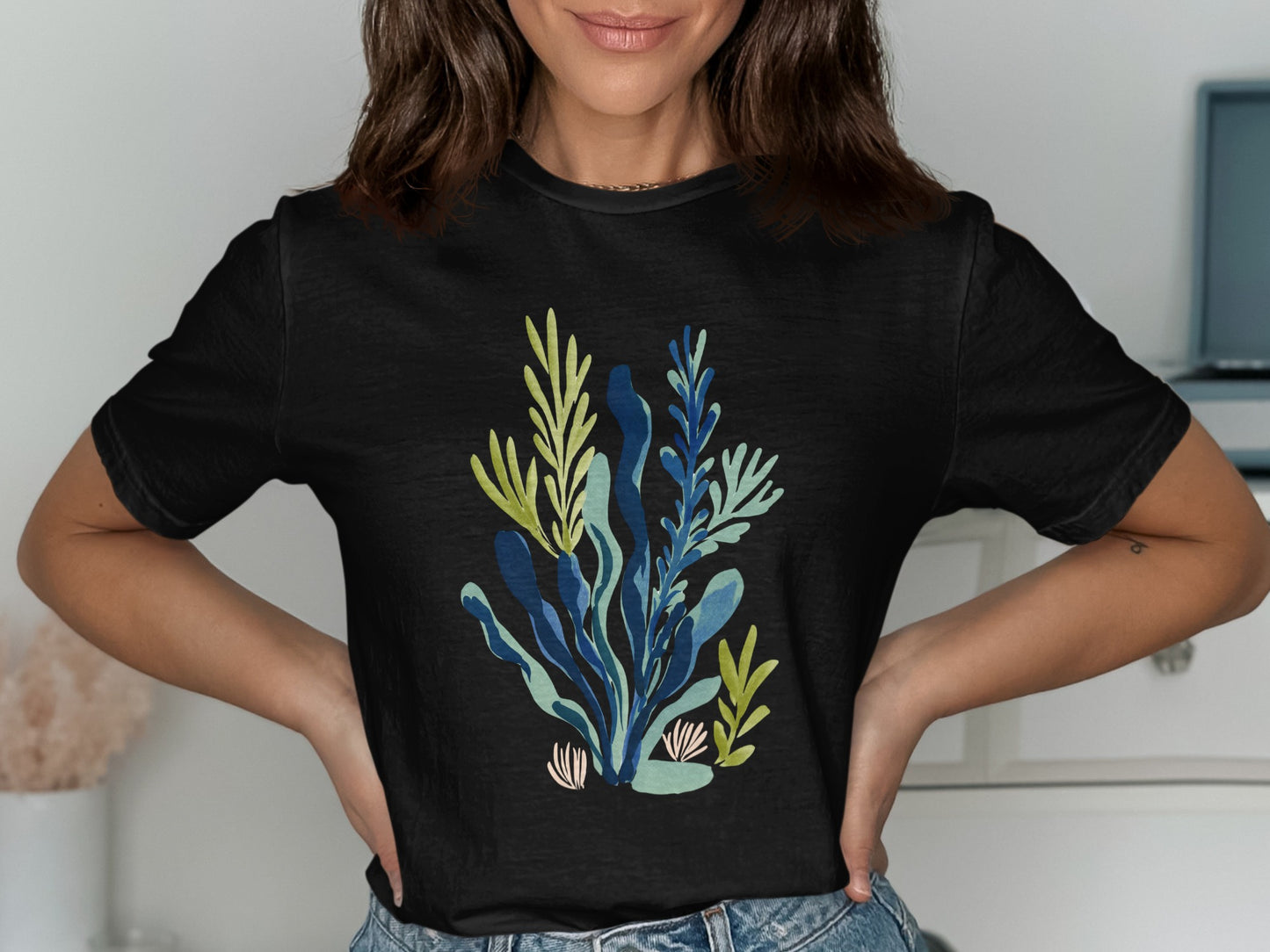 Black t-shirt with a blue and green abstract botanical print.