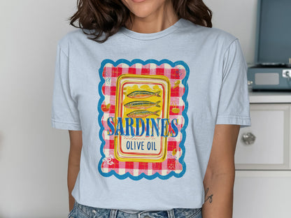 T-shirt with a framed illustration of a sardine tin labeled "Sardines Olive Oil".