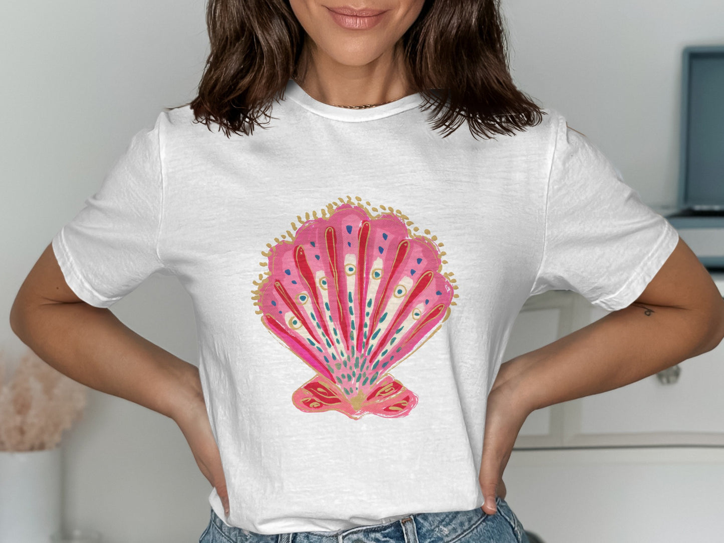 White t-shirt with a pink seashell graphic.