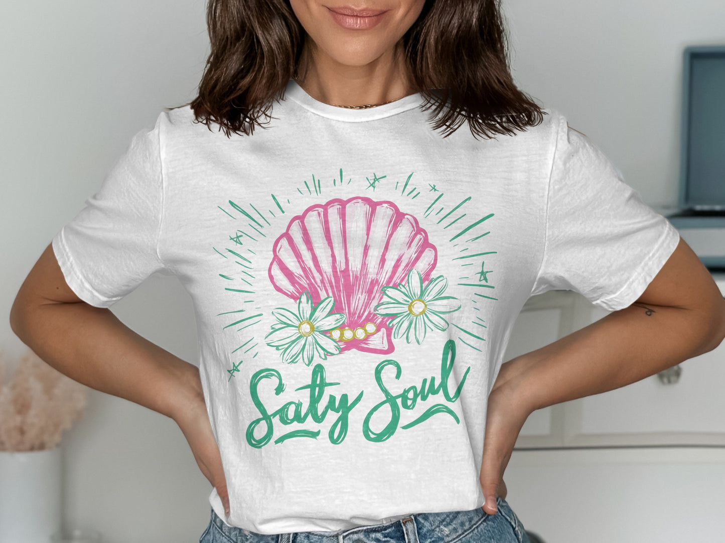 White t-shirt with pink seashell, daisies, and "Salty Soul" text.