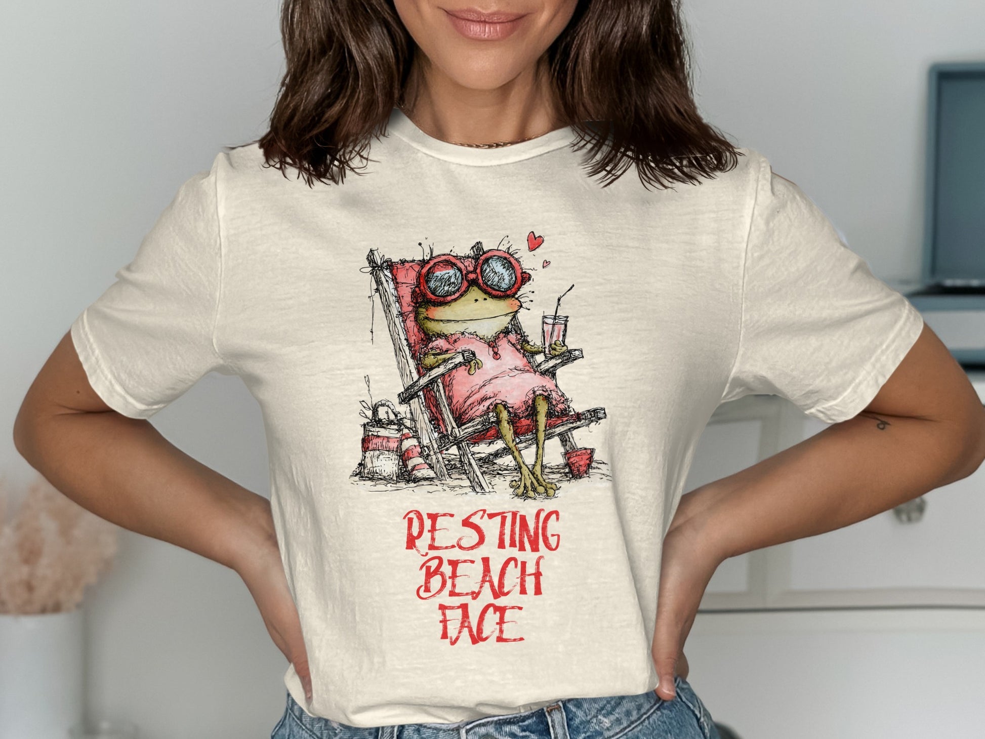 Illustration of a frog wearing sunglasses lounging in a beach chair with "RESTING BEACH FACE" text.