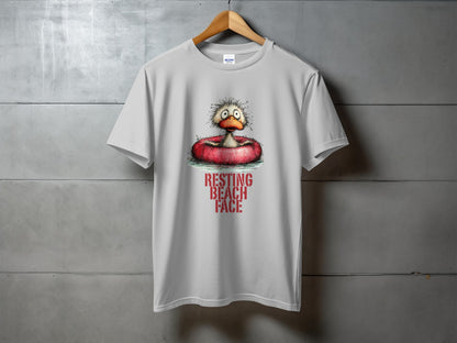 White t-shirt with graphic of cartoon duck in inflatable ring with "RESTING BEACH FACE" text.