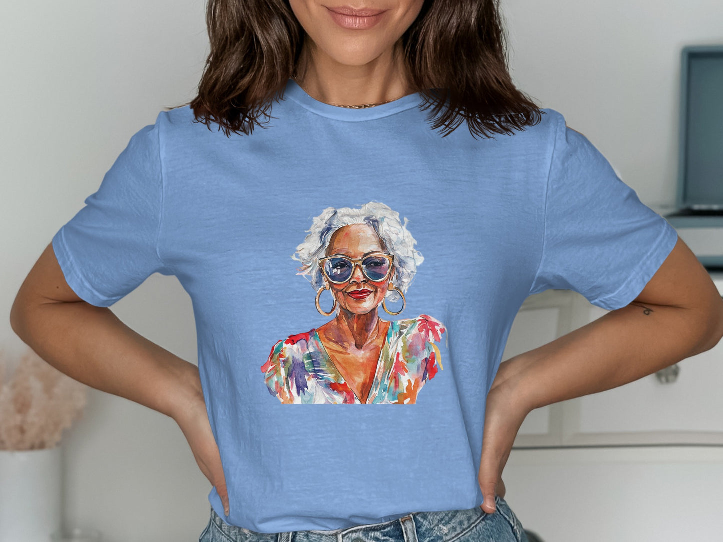 Woman wearing a blue t-shirt with a vibrant floral portrait.