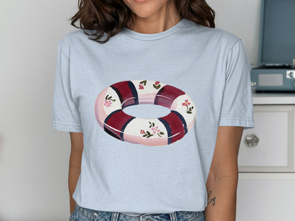 Light blue t-shirt featuring a float with floral and striped pattern.