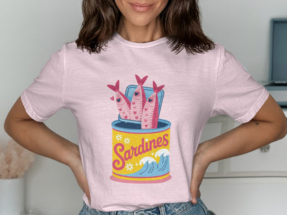 Pink t-shirt with cartoon sardines in a can with waves and flowers.