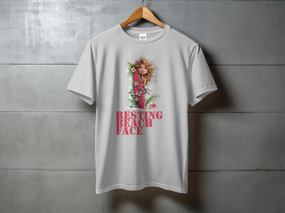 White t-shirt with "RESTING BEACH FACE" and a girl with a surfboard.