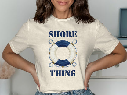 Cream t-shirt with blue "SHORE THING" text and a nautical rope-bound life preserver.