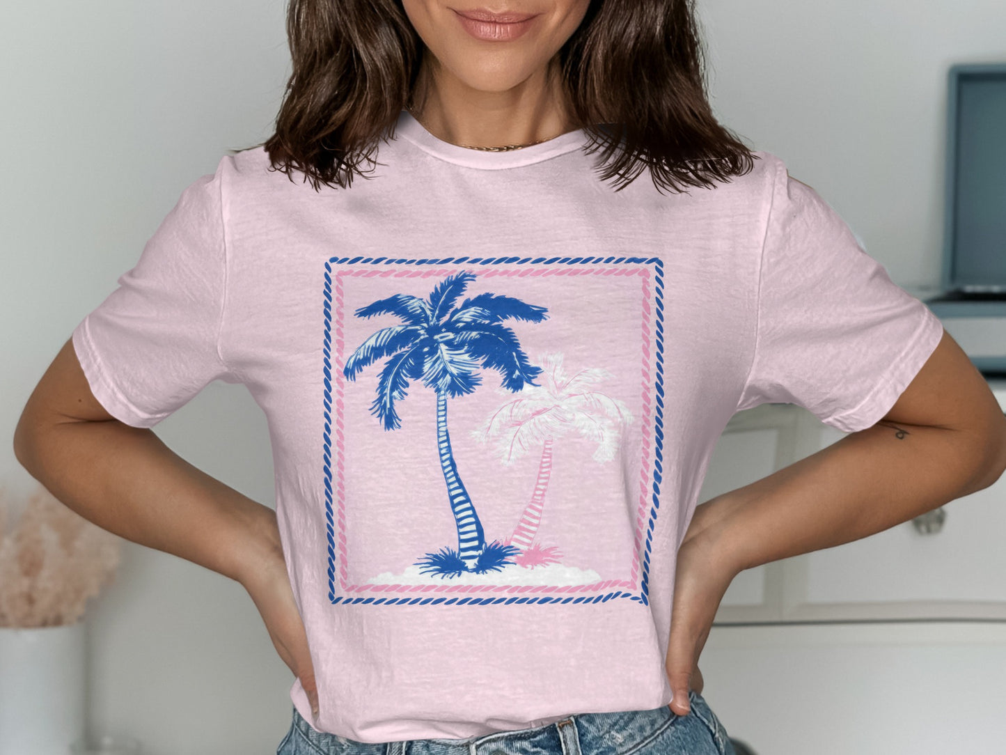 Pink t-shirt with blue and white palm trees in a square border.