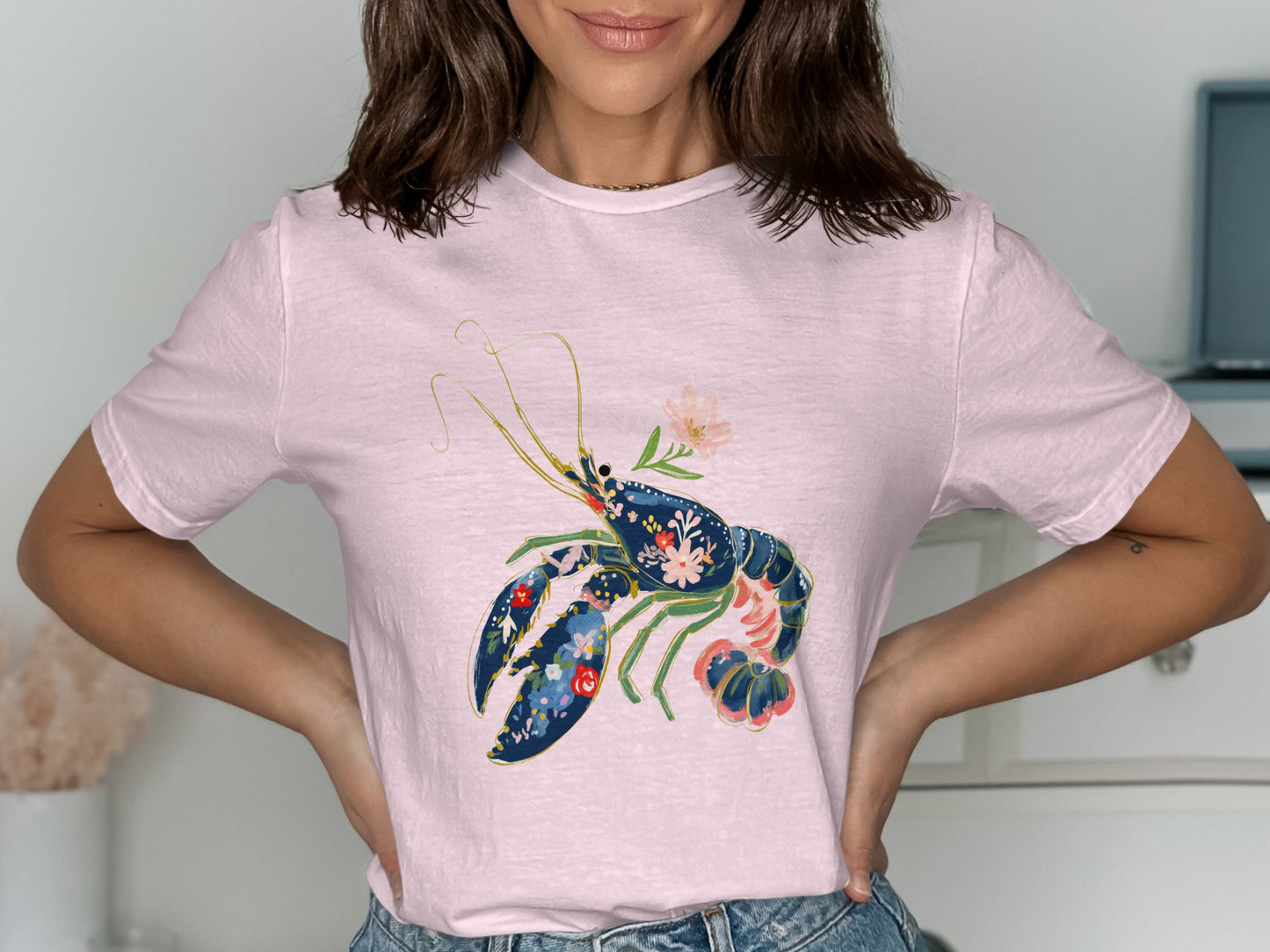 Pink t-shirt featuring a blue and red floral lobster graphic.