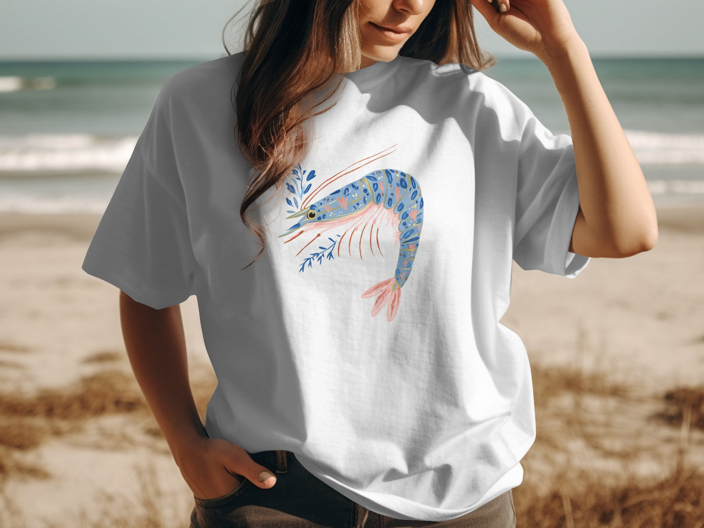 White t-shirt with a stylized blue shrimp and floral design.