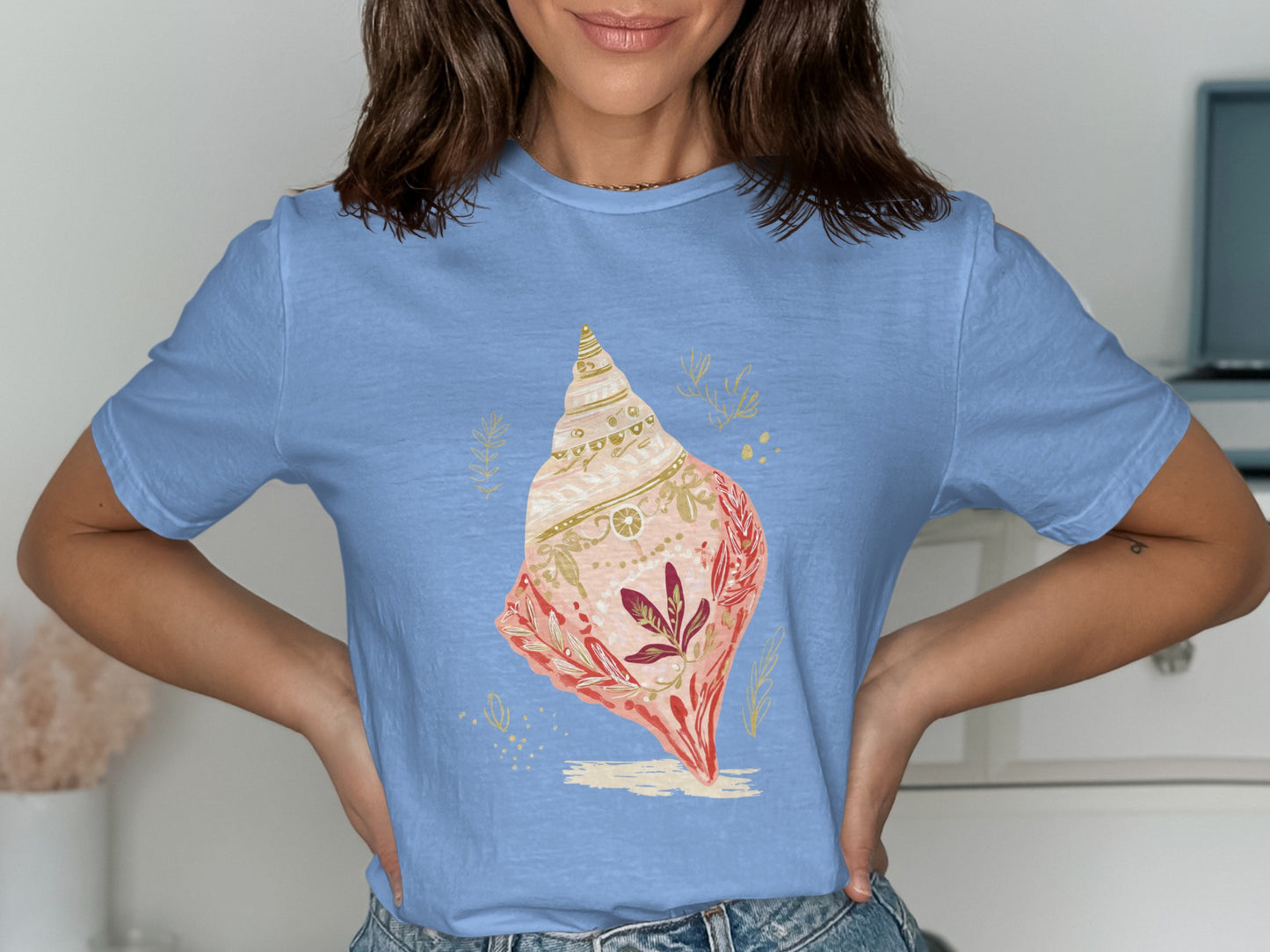 Light blue t-shirt with a decorative seashell design.