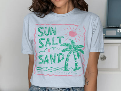 Light blue t-shirt with pink graphic: SUN SALT & SAND, palm tree, and sun.