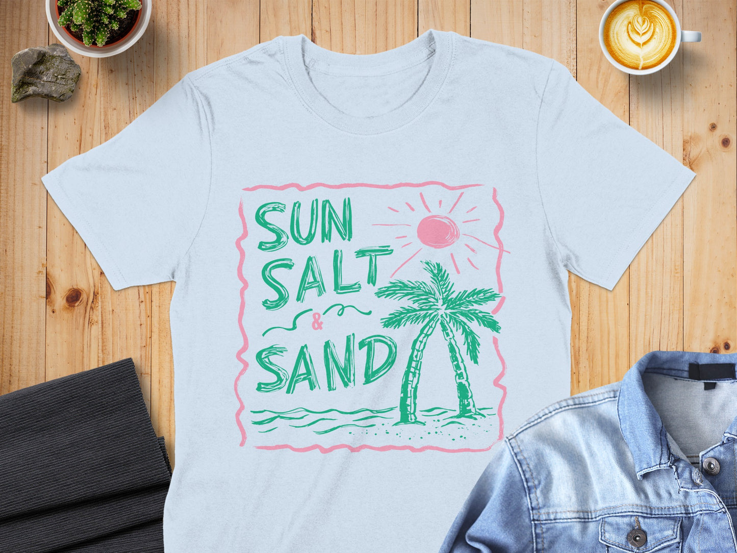 Light blue t-shirt with "Sun Salt & Sand" palm tree graphic.