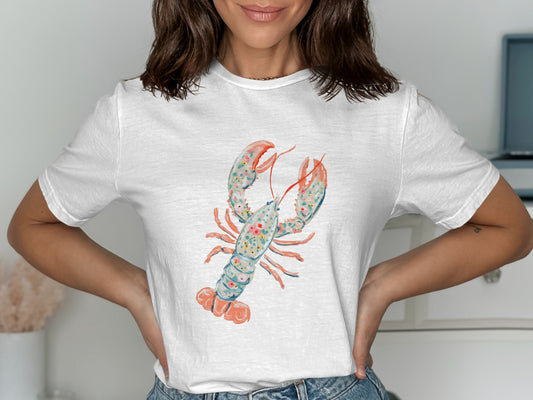 White t-shirt featuring a watercolor lobster with floral accents.